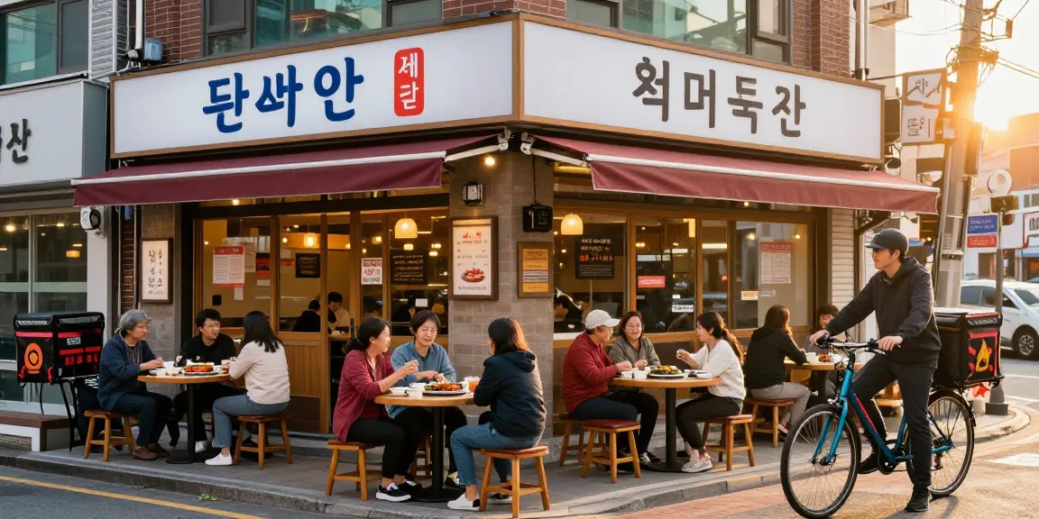 People enjoying traditional Korean dishes at 상봉동 한국관, capturing vibrant street dining atmosphere.